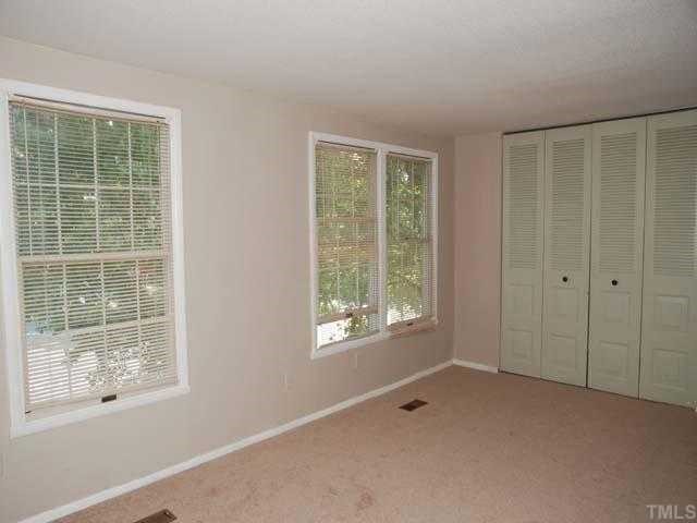 7735 Sandra Lane Raleigh, NC 27615 - Photo 6 of 8 Neutral carpet, designer neutral wall paint, single and double window with mini blinds, double closet