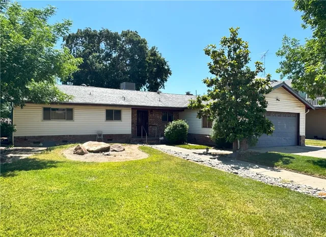 a backyard of a house with table and chairs