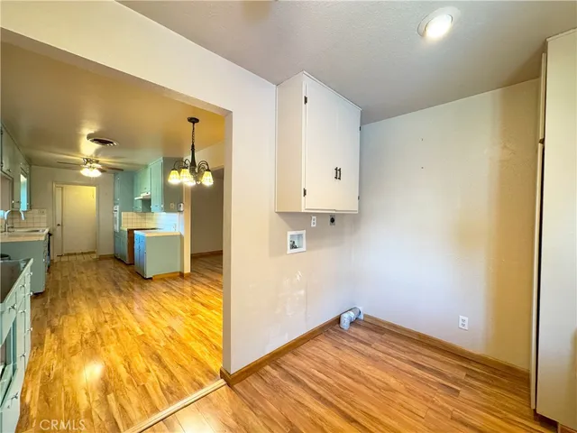 a view of a kitchen with a sink and wooden floor