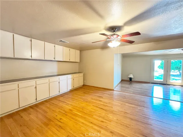 a view of a room with wooden floor