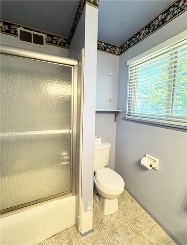 a spacious bathroom with a granite countertop sink mirror and a bathtub