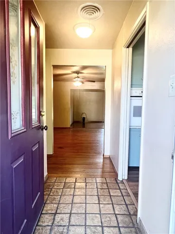a view of an entryway with wooden floor