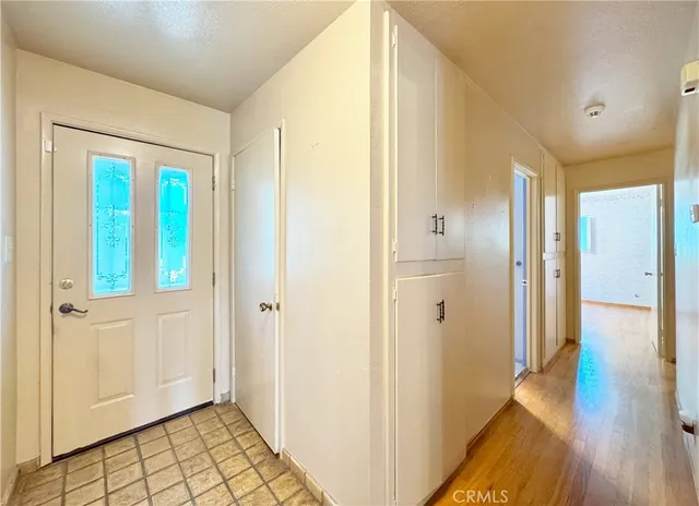 a large kitchen with a lot of counter space and wooden floor