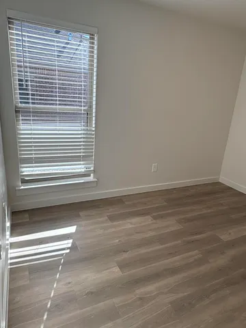 a bathroom with a granite countertop bathtub sink vanity mirror and toilet