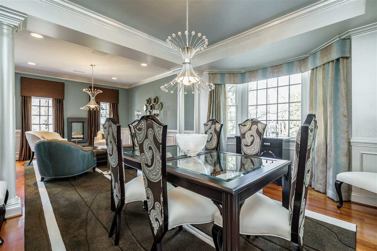 3916 Hemsbury Way Raleigh, NC 27612 - Photo 5 of 30 Silvery hand painted designed walls, a glamorous crystal chandelier and fresh window curtains add style and beauty to this special area for entertaining! Dining Room