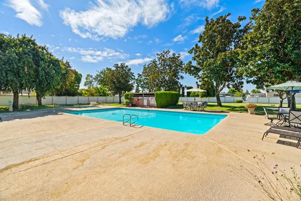 a view of a swimming pool with a yard
