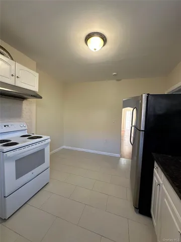 a kitchen with a stove and a refrigerator