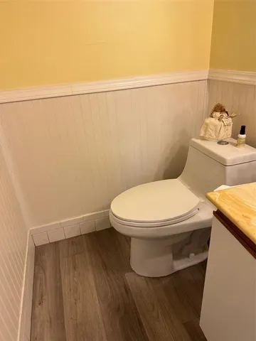 a white toilet sitting next to a bathroom sink