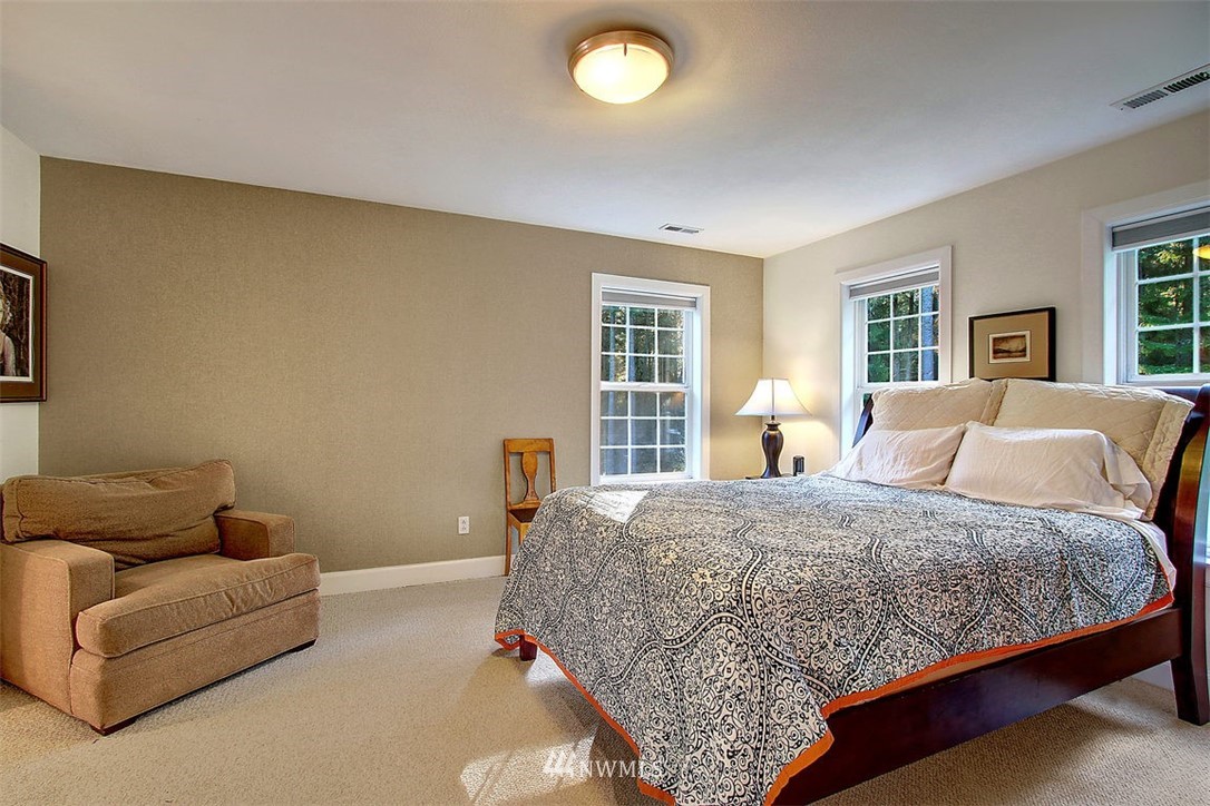 6615 Cultus Bay Road Clinton, WA 98236 - Photo 12 of 25 a bedroom with a bed couch and window