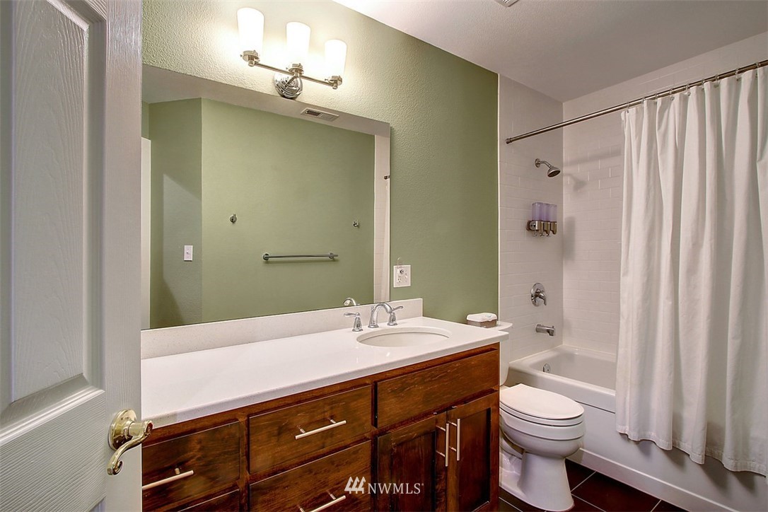 6615 Cultus Bay Road Clinton, WA 98236 - Photo 17 of 25 a bathroom with a sink a toilet and a mirror