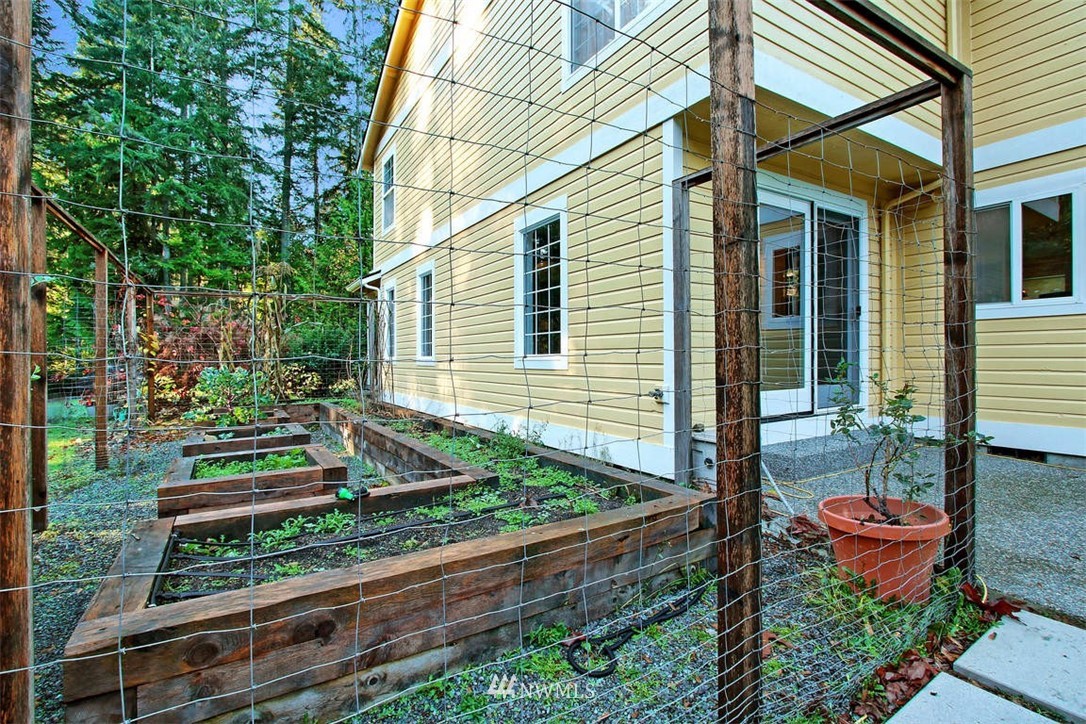 6615 Cultus Bay Road Clinton, WA 98236 - Photo 24 of 25 a front view of house with yard and outdoor seating