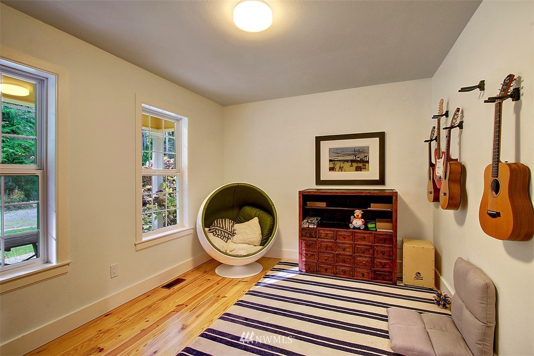 6615 Cultus Bay Road Clinton, WA 98236 - Photo 9 of 25 a living room with furniture a window and a fireplace