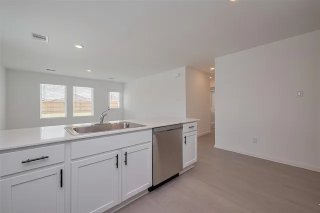 a kitchen with sink and window