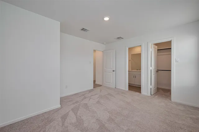 a view of an empty room and closet area