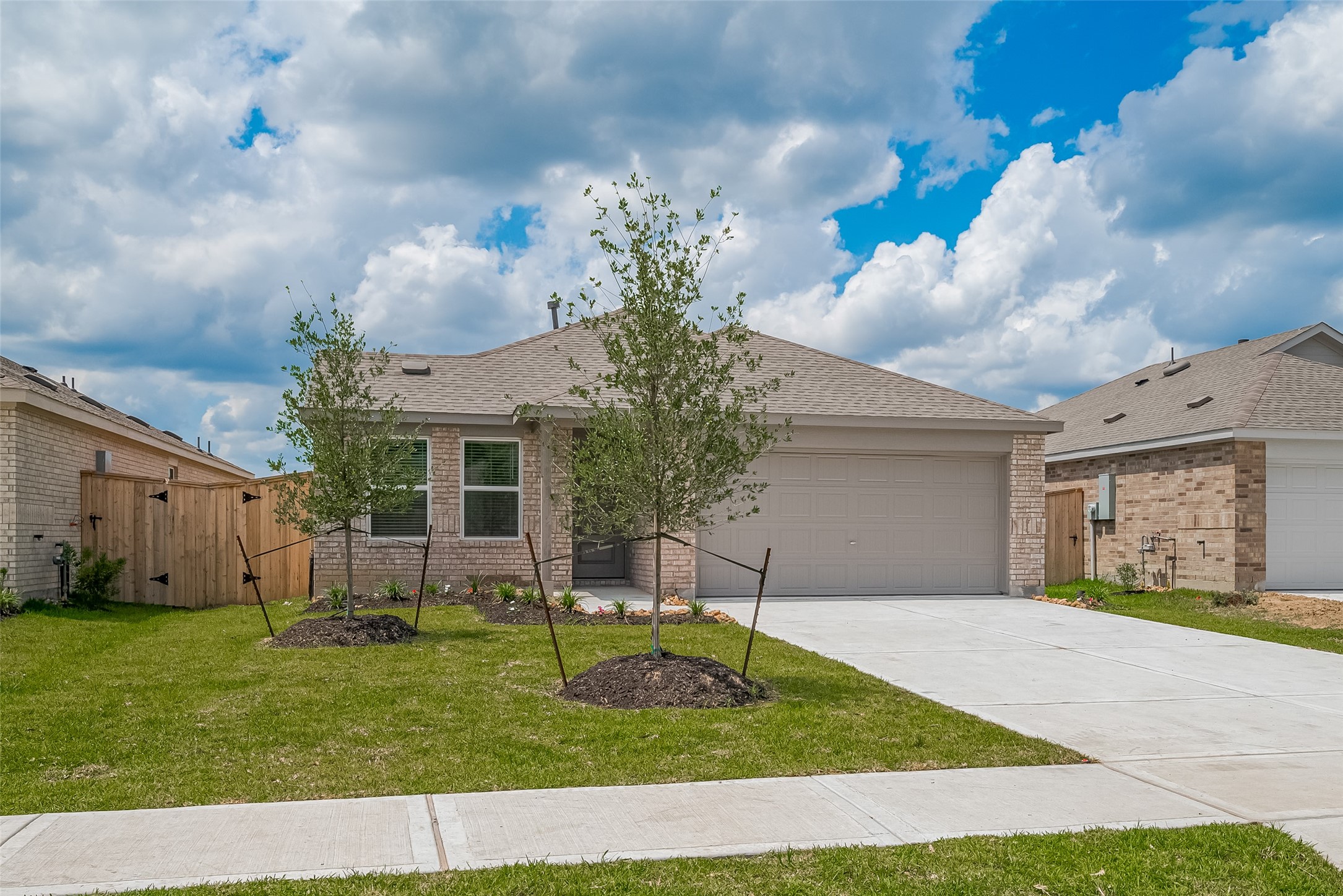 21459 Montecagnano Avenue New Caney, TX 77357 - Photo 2 of 27 a front view of a house with garden