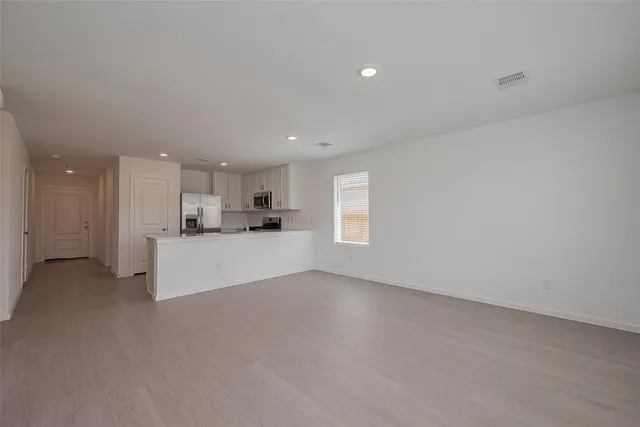 a view of kitchen and kitchen with window