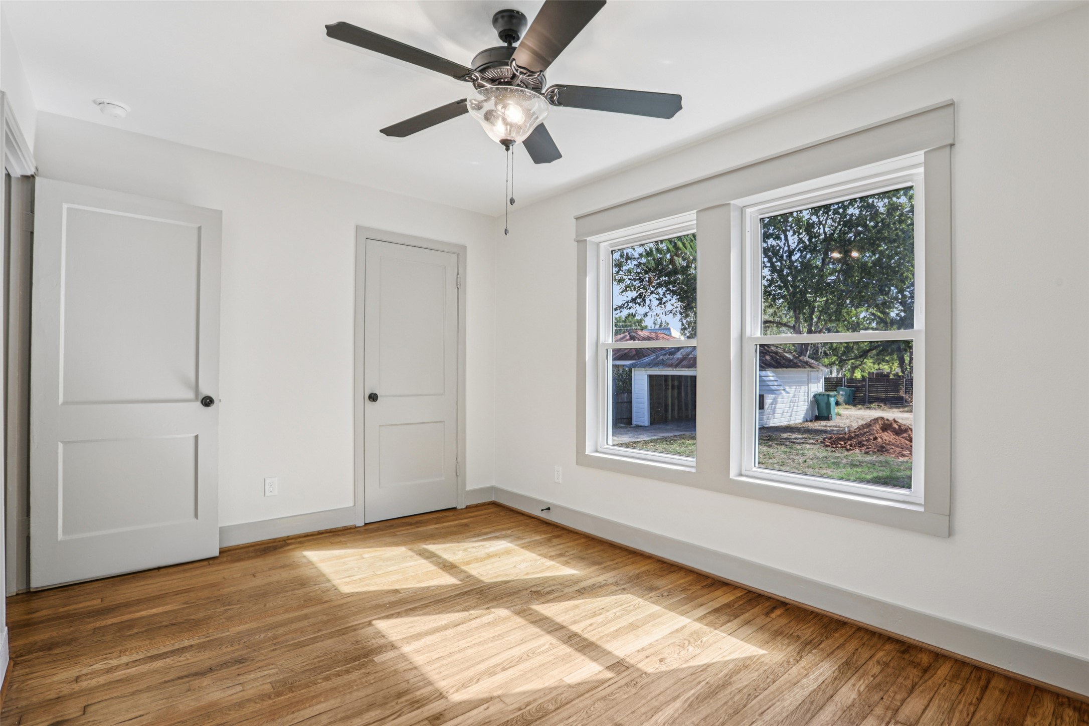 602 Short Street Smithville, TX 78957 - Photo 20 of 27 a view of an empty room with a window and wooden floor