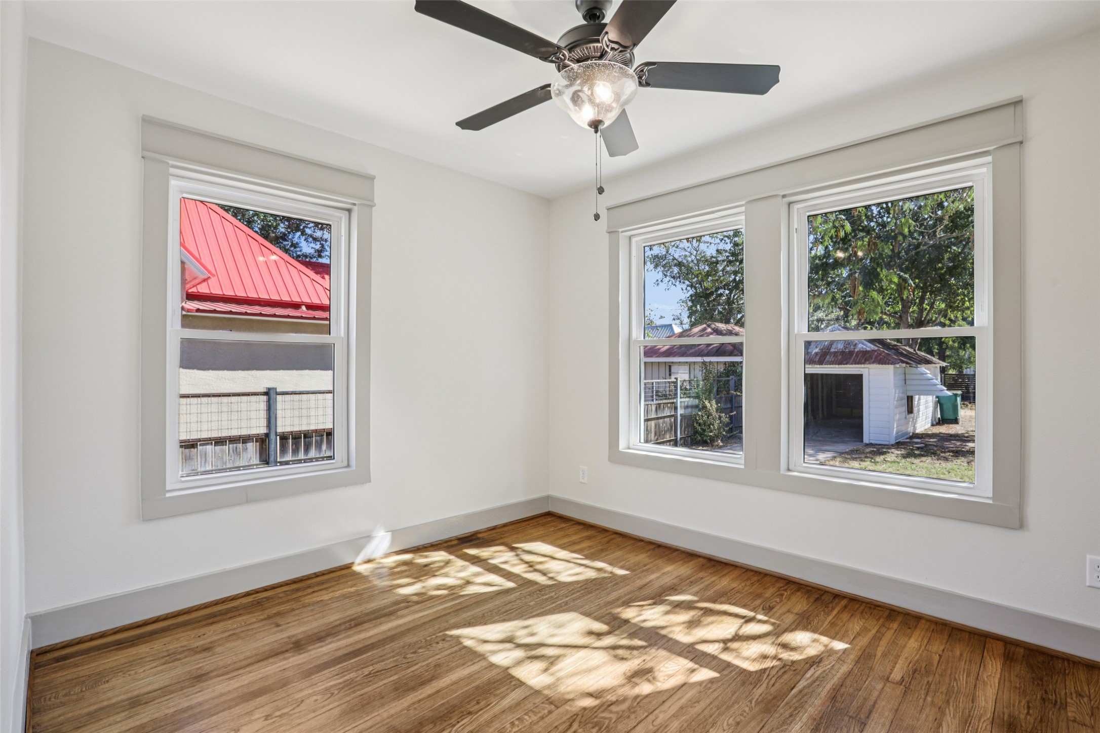 602 Short Street Smithville, TX 78957 - Photo 23 of 27 a view of an empty room with wooden floor and a window