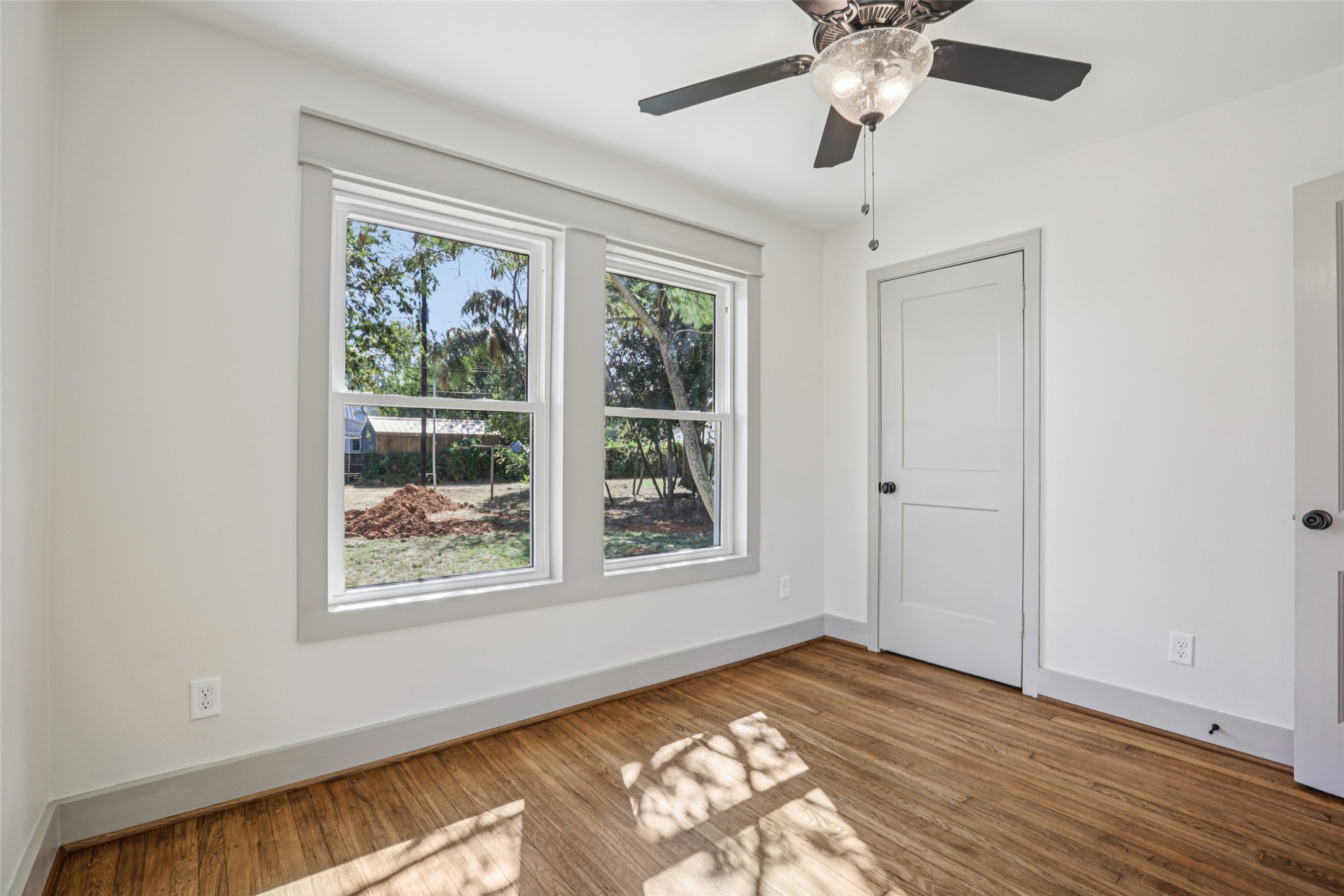 602 Short Street Smithville, TX 78957 - Photo 24 of 27 a view of an empty room with wooden floor and a window