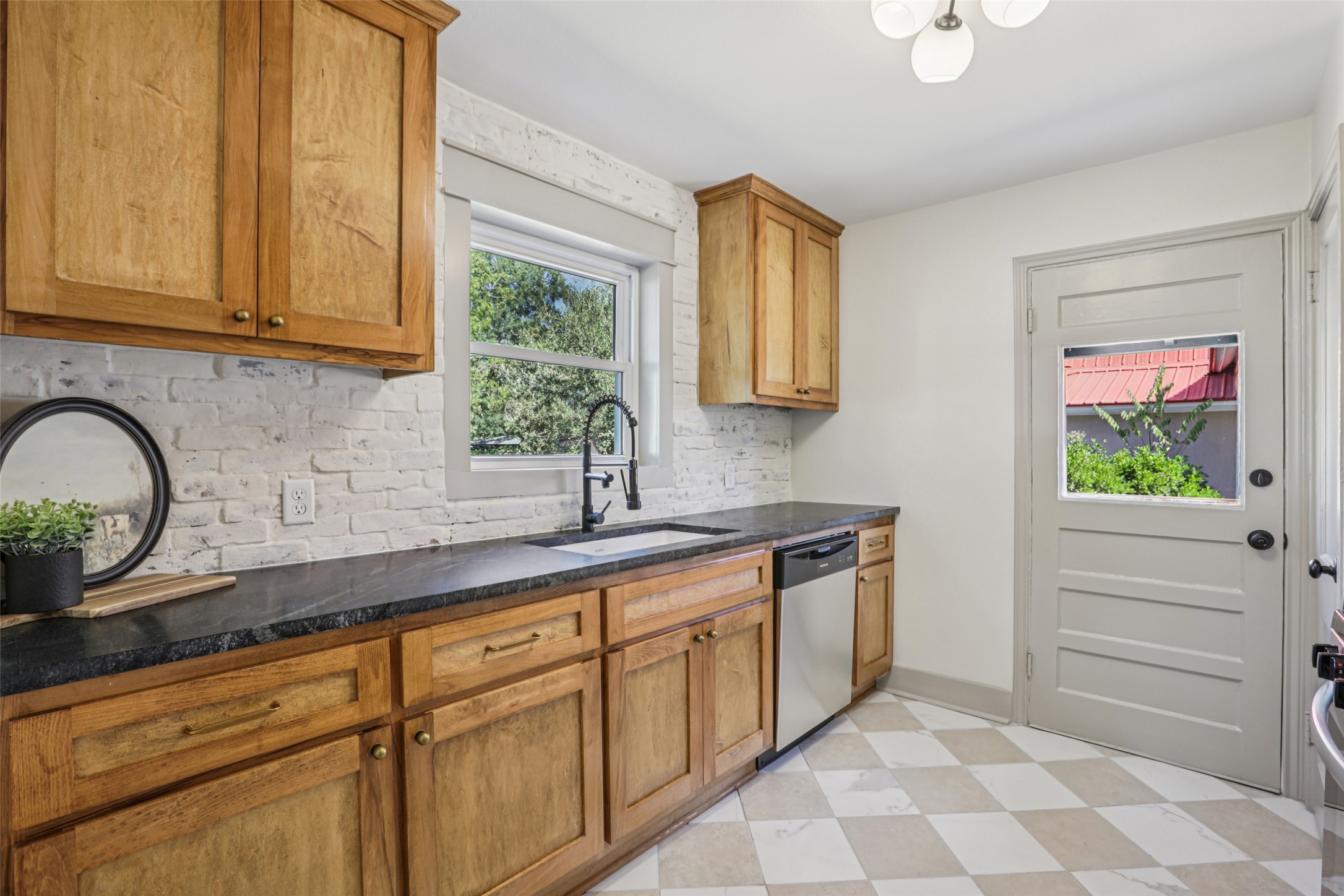 602 Short Street Smithville, TX 78957 - Photo 3 of 27 a kitchen with granite countertop stainless steel appliances a sink and a window