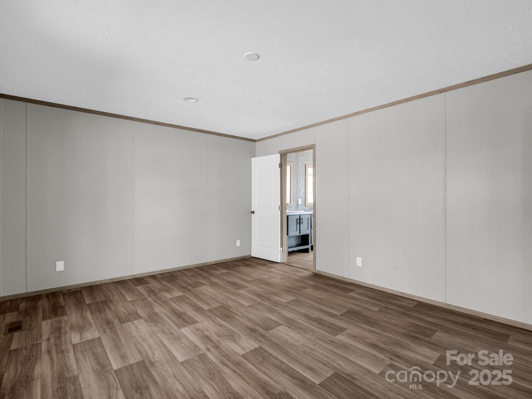 844 Tiney Road Ellenboro, NC 28040 - Photo 15 of 45 a view of an empty room with wooden floor