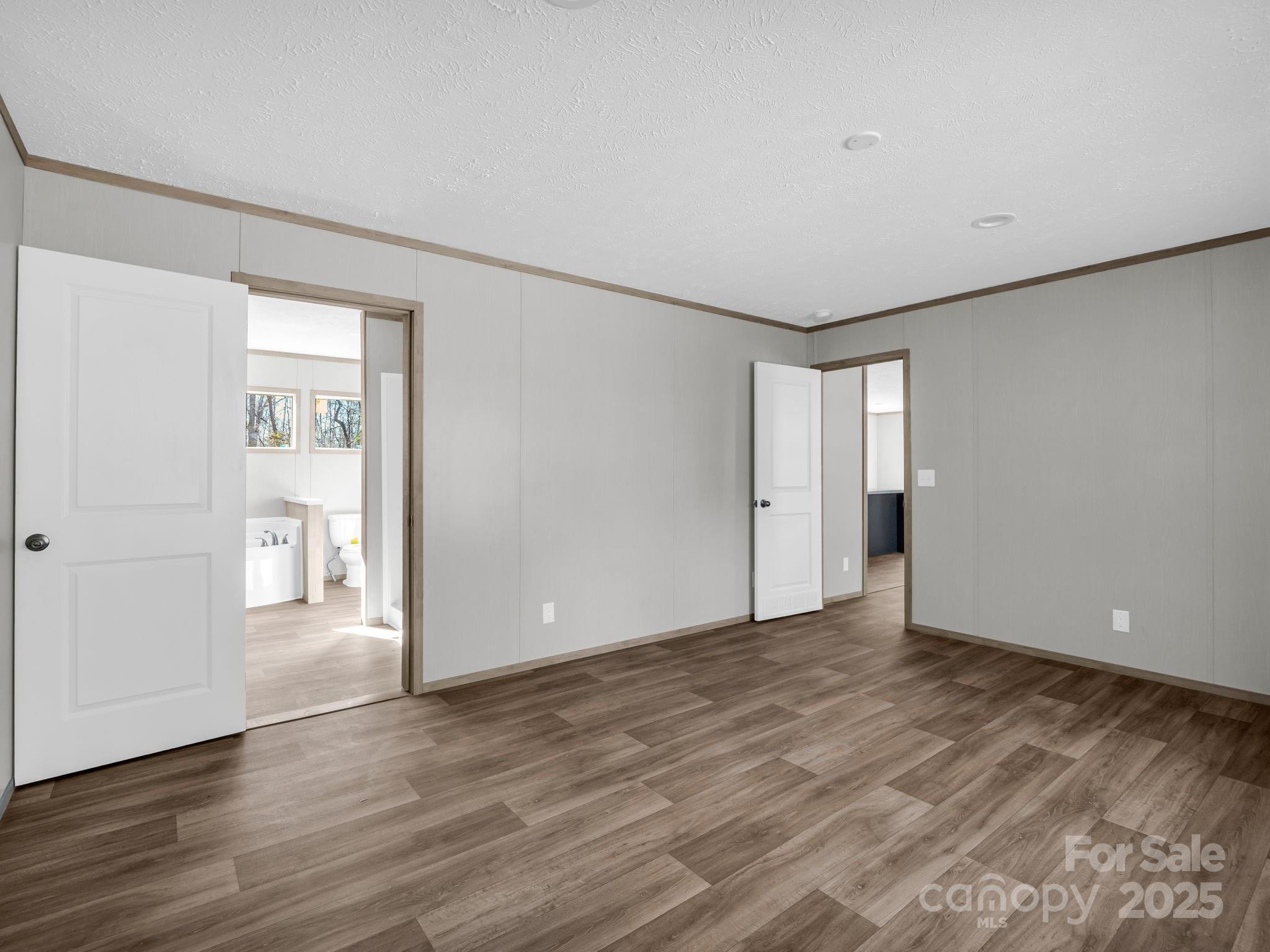 844 Tiney Road Ellenboro, NC 28040 - Photo 16 of 45 a view of an empty room with wooden floor and closet