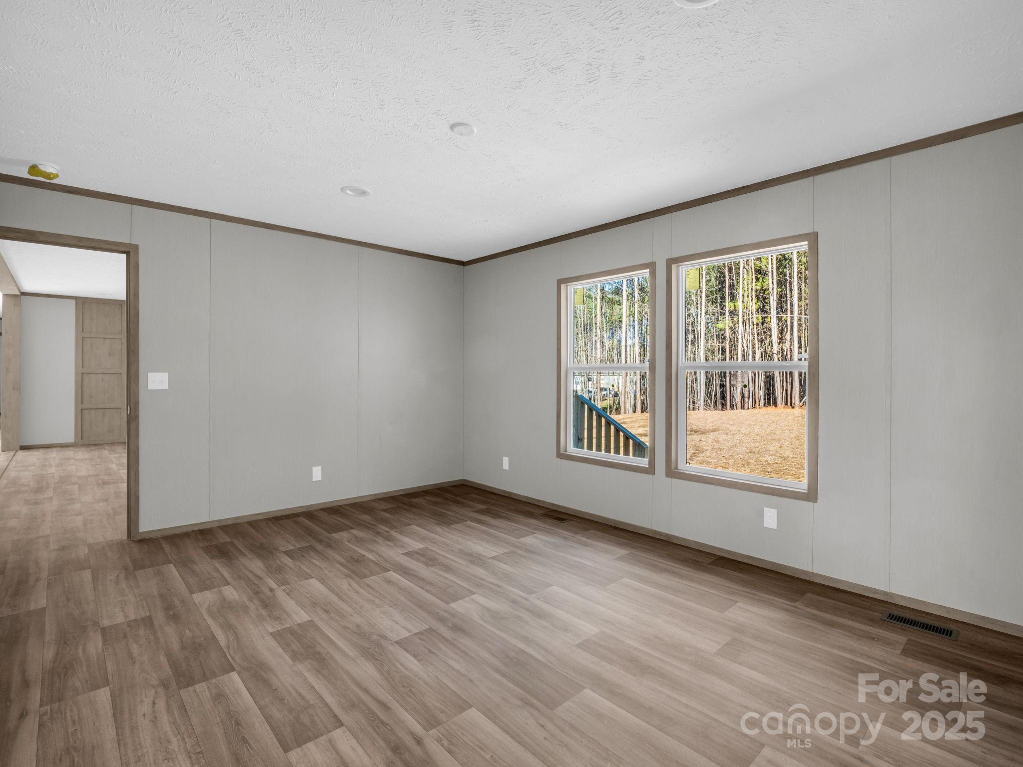 844 Tiney Road Ellenboro, NC 28040 - Photo 17 of 45 a view of an empty room with wooden floor and a window