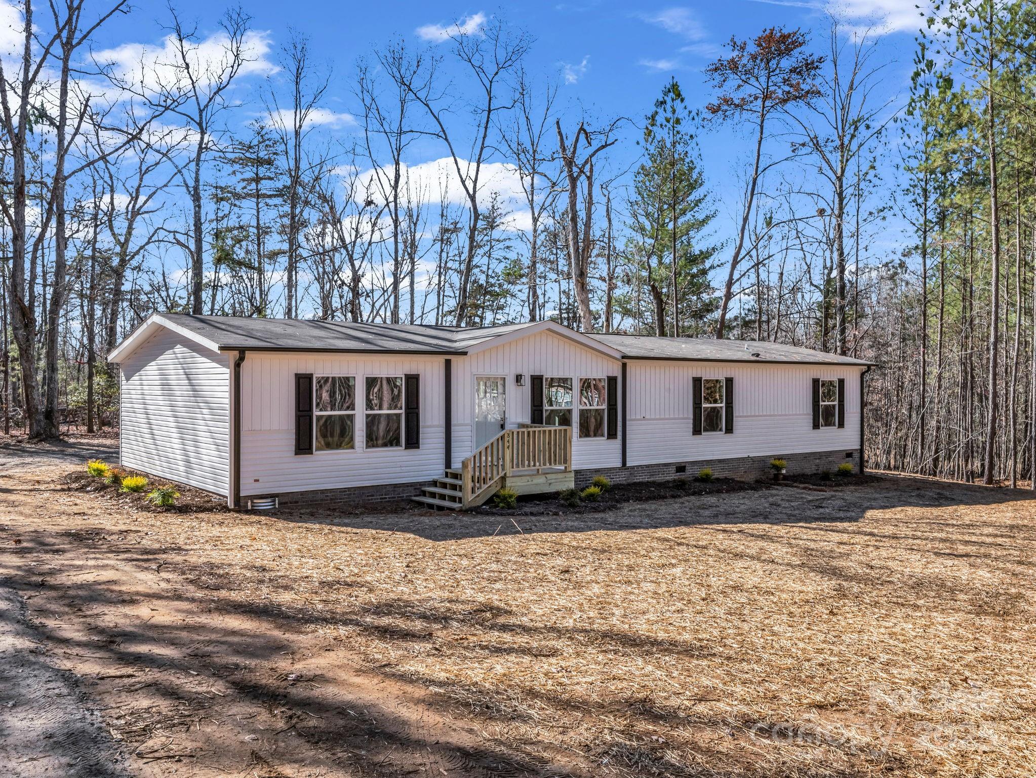 844 Tiney Road Ellenboro, NC 28040 - Photo 2 of 45 a view of a house with a yard covered in snow