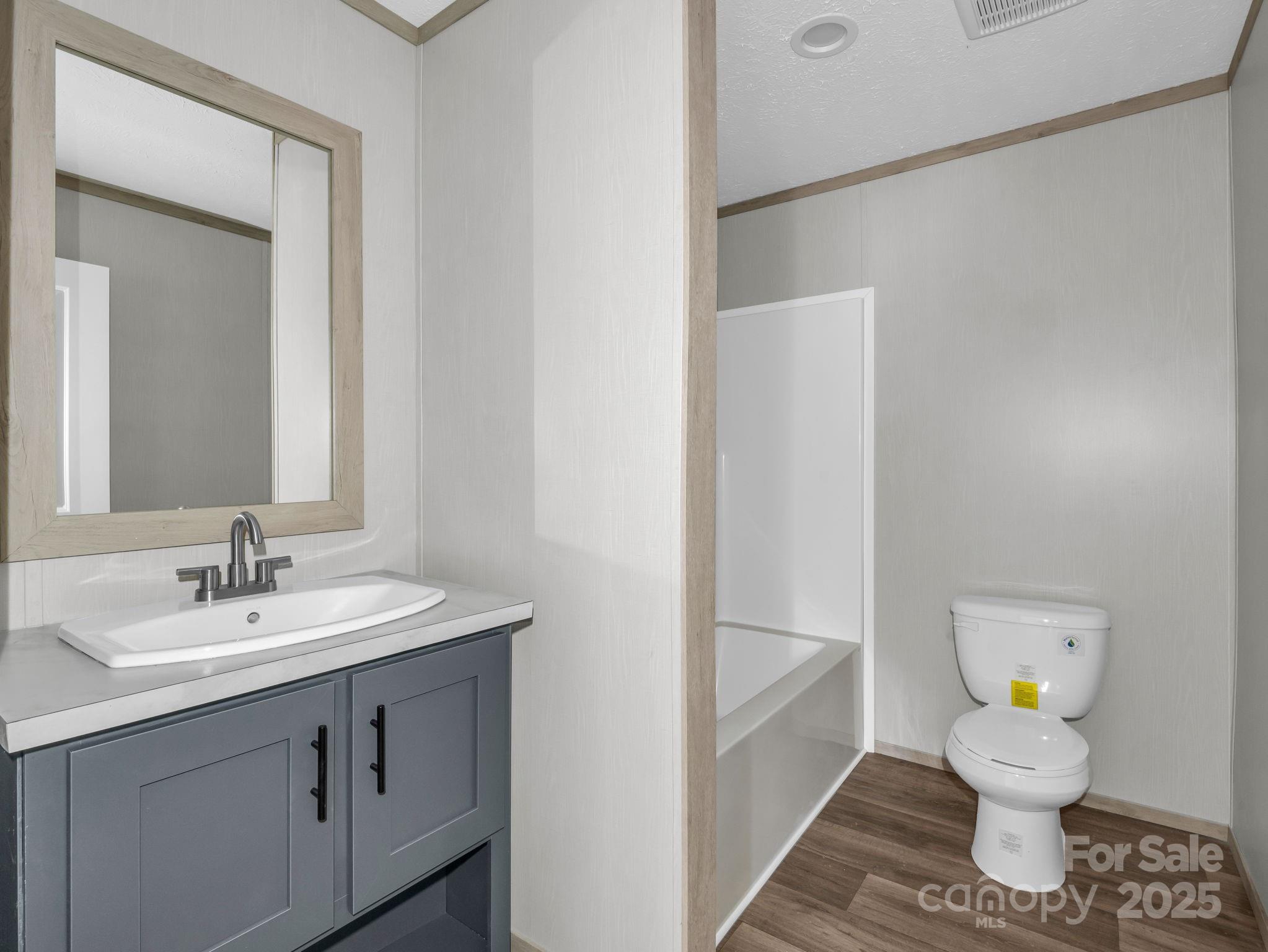 844 Tiney Road Ellenboro, NC 28040 - Photo 25 of 45 a bathroom with a sink toilet and a mirror