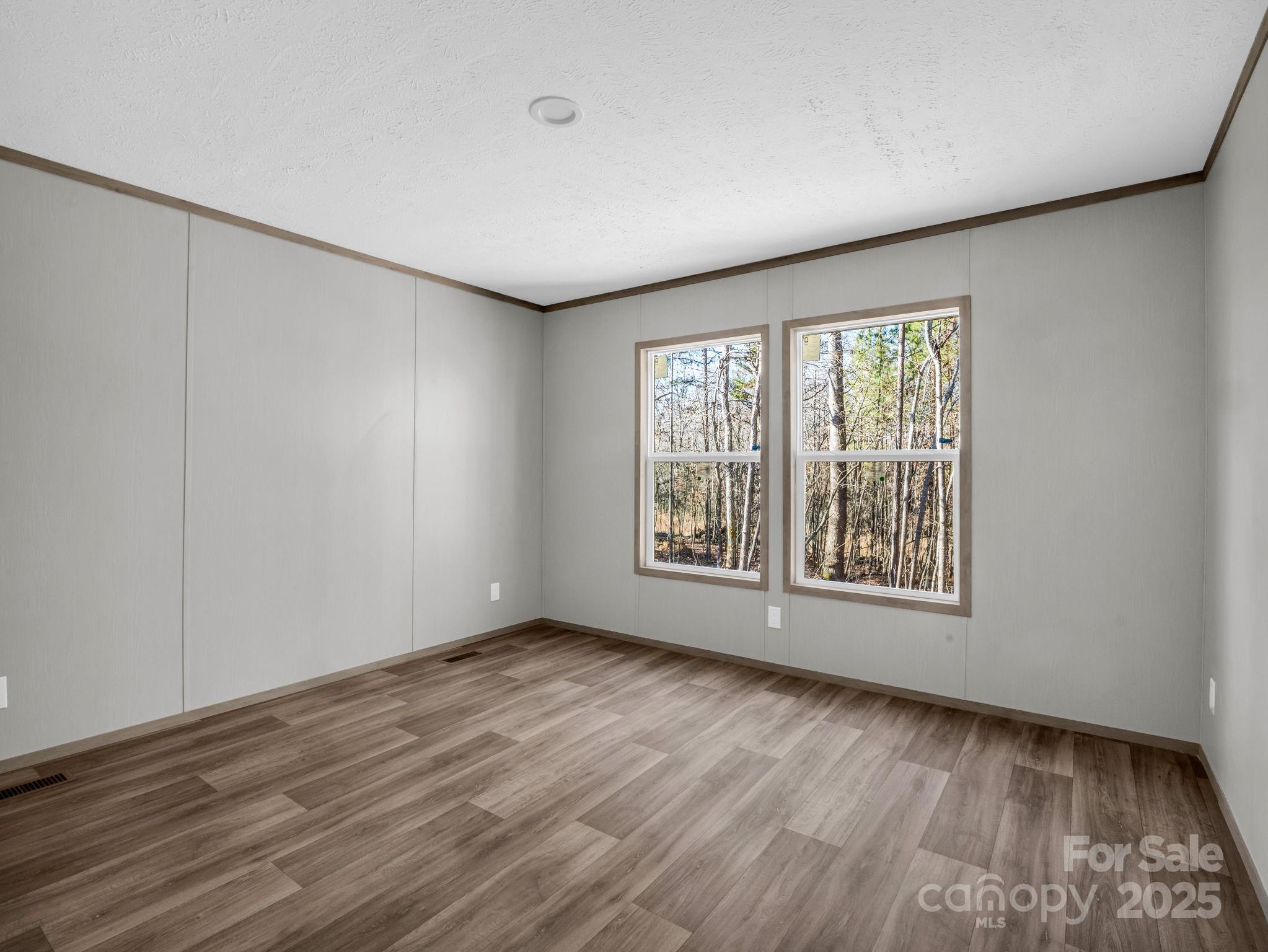 844 Tiney Road Ellenboro, NC 28040 - Photo 28 of 45 a view of an empty room with wooden floor and a window