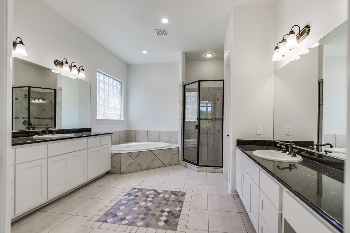 2617 University Club Drive Austin, TX 78732 - Photo 11 of 25 a large bathroom with a granite countertop sink a toilet a mirror and shower