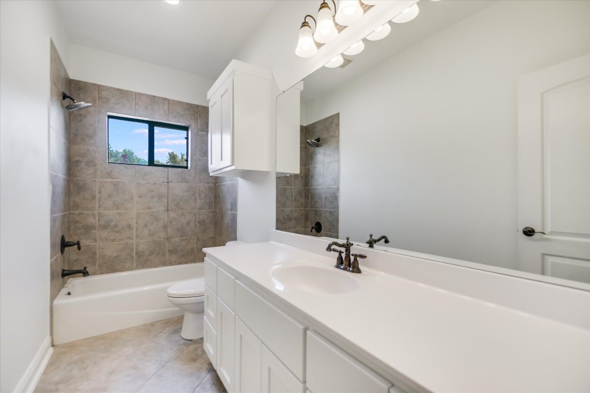 2617 University Club Drive Austin, TX 78732 - Photo 14 of 25 a bathroom with a bathtub a sink and a large mirror