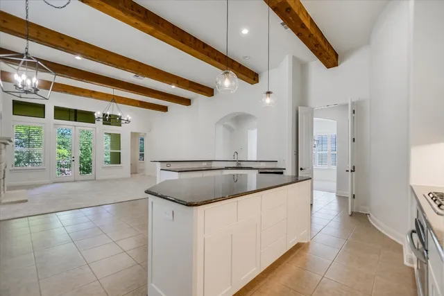 a kitchen with stainless steel appliances granite countertop a sink and a stove