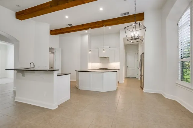 a large white kitchen with a large window