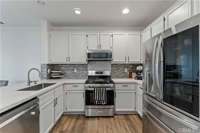 a kitchen with a sink stove and refrigerator