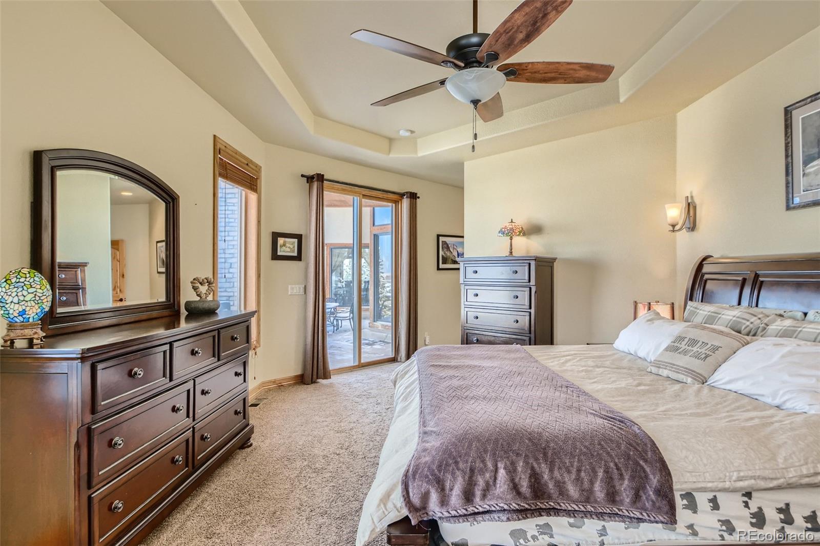 11227 Explorers Run Littleton, CO 80125 - Photo 16 of 33 a bedroom with a large bed and a dresser