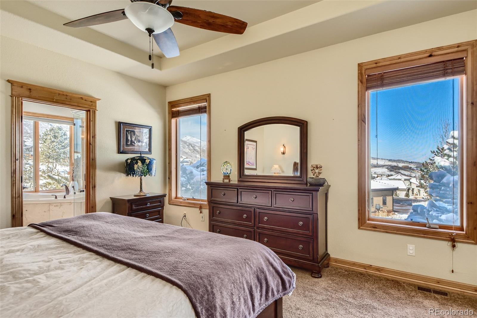 11227 Explorers Run Littleton, CO 80125 - Photo 17 of 33 a bedroom with a bed and a dresser