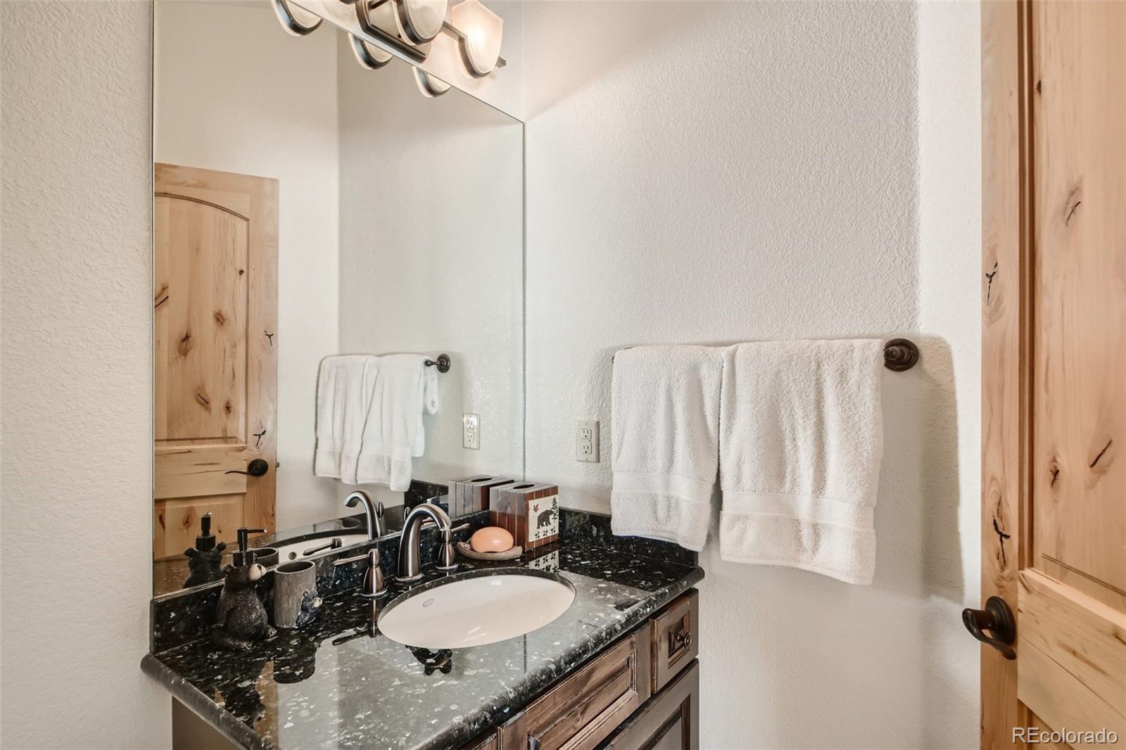 11227 Explorers Run Littleton, CO 80125 - Photo 24 of 33 a bathroom with a sink double vanity and a mirror