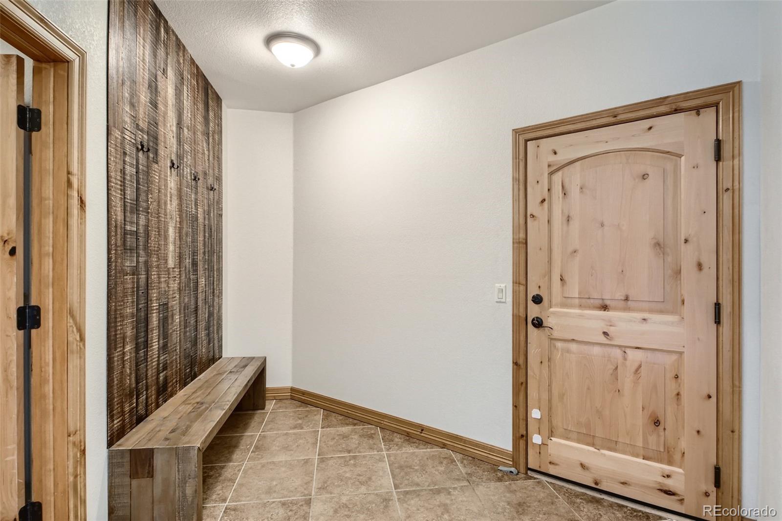 11227 Explorers Run Littleton, CO 80125 - Photo 28 of 33 a view of a hallway with wooden floor and closet area