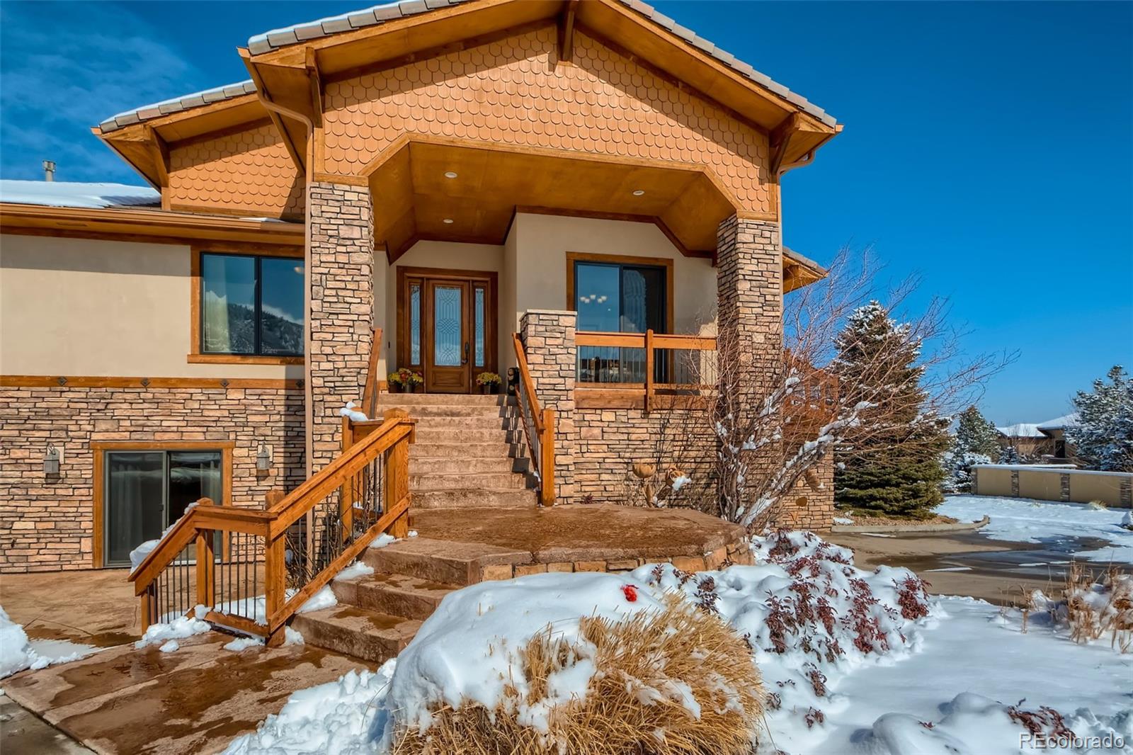 11227 Explorers Run Littleton, CO 80125 - Photo 3 of 33 a front view of a house with a yard