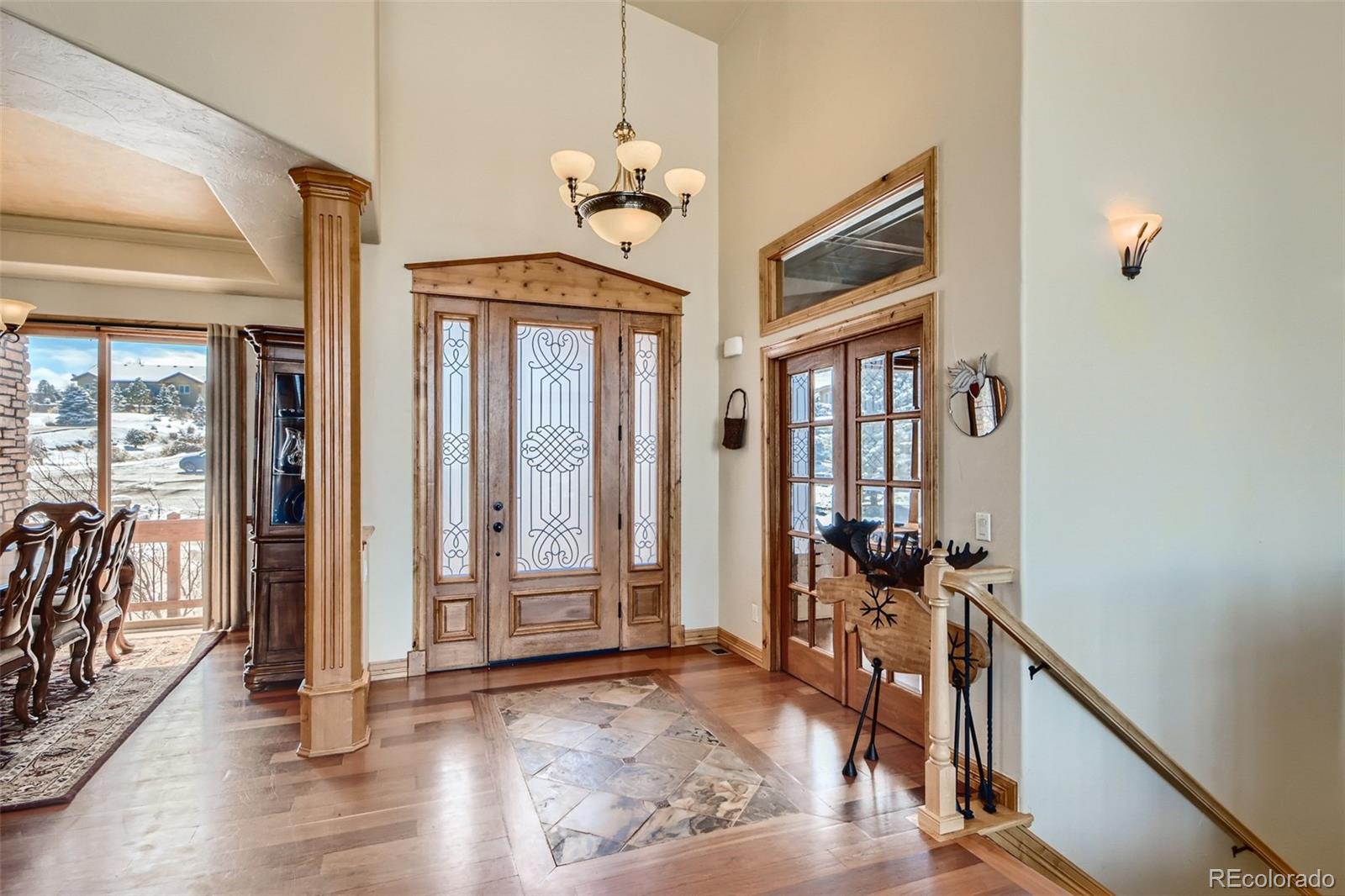 11227 Explorers Run Littleton, CO 80125 - Photo 4 of 33 a view of a livingroom with wooden floor and windows
