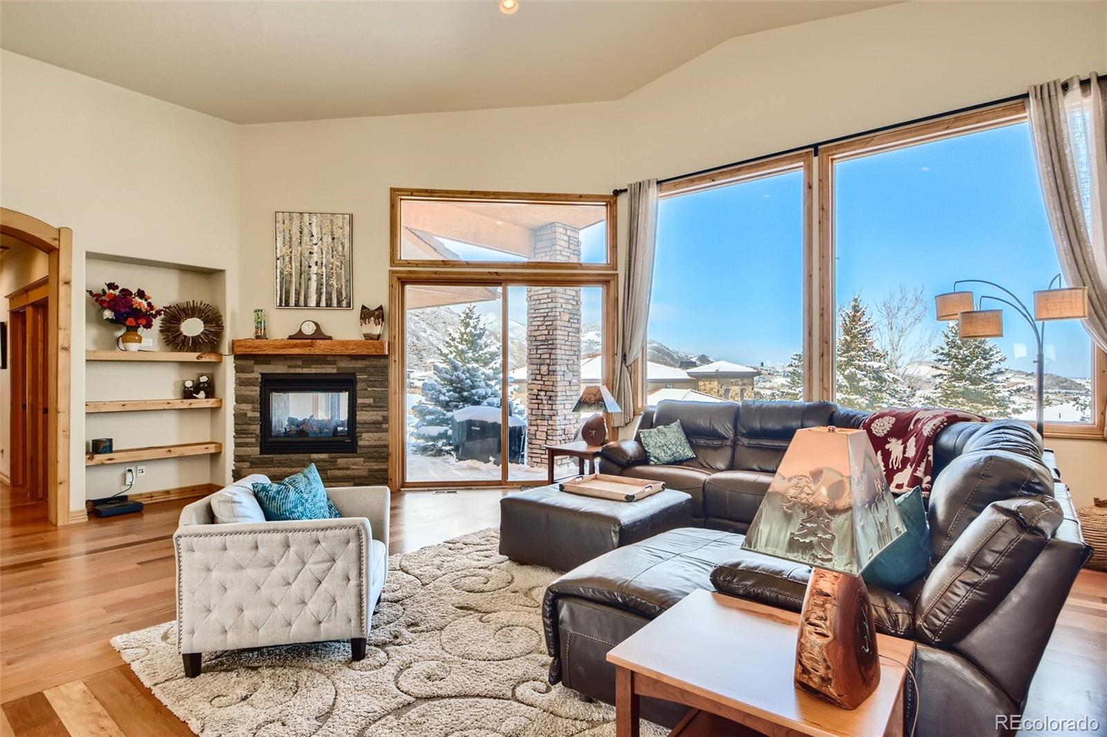 11227 Explorers Run Littleton, CO 80125 - Photo 7 of 33 a living room with furniture fireplace and a large window