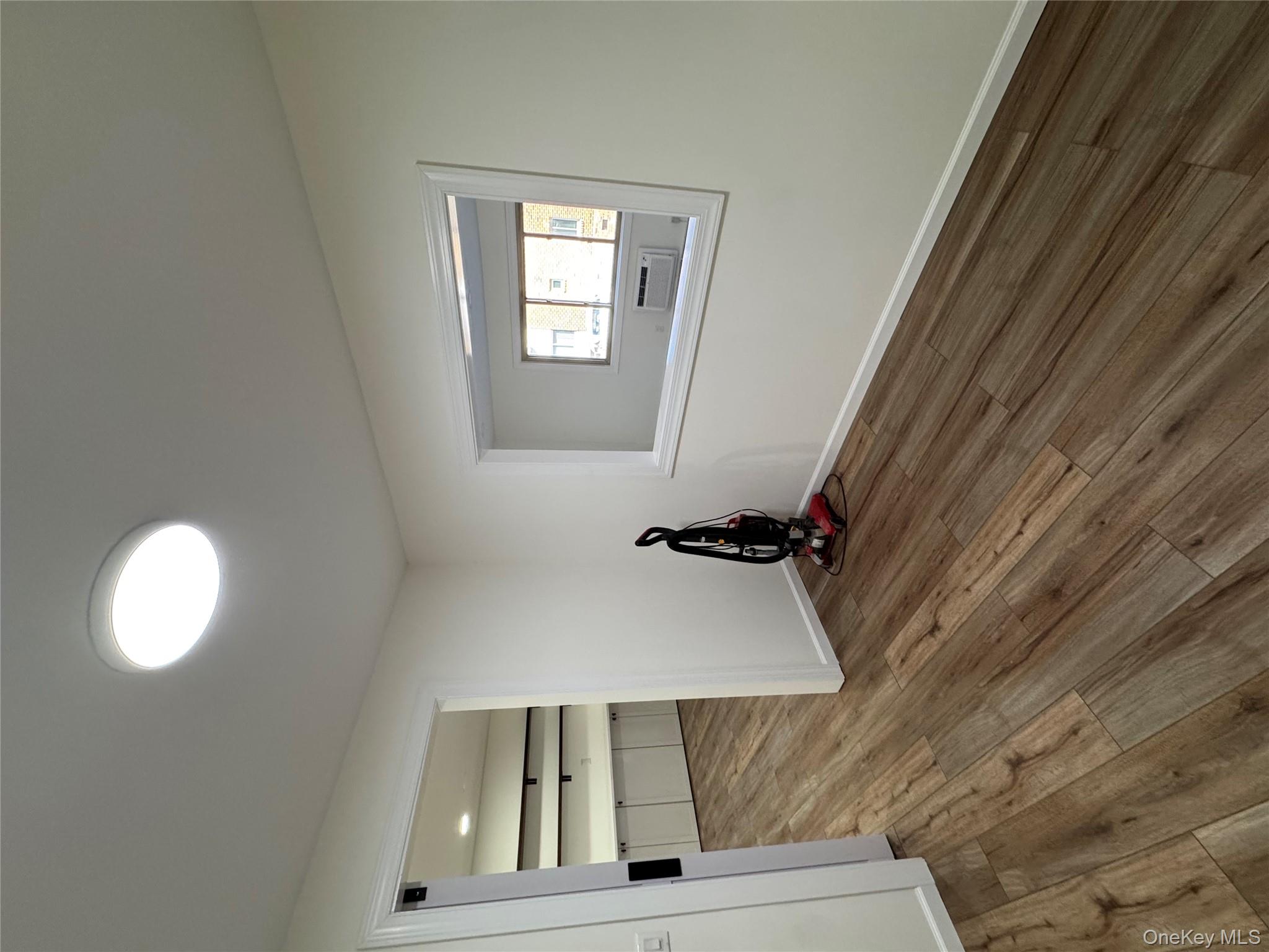 2449 I Union Avenue, Unit 34A Islip, NY 11751 - Photo 14 of 19 a view of an empty room with a window and wooden floor