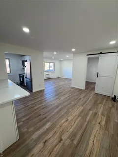 a view of a room with wooden floor