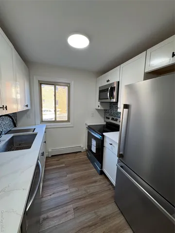 a kitchen with a refrigerator stove and microwave