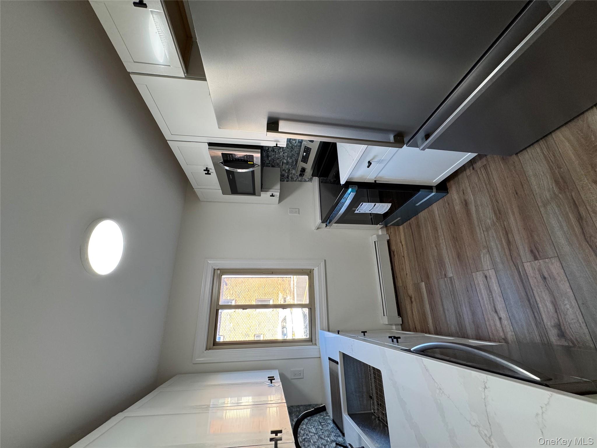 2449 I Union Avenue, Unit 34A Islip, NY 11751 - Photo 8 of 19 a kitchen with a refrigerator stove and microwave