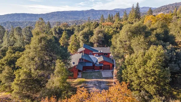 a view of a house with a yard and mountain