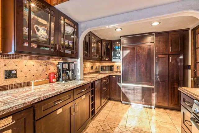 a kitchen with stainless steel appliances granite countertop a stove and a microwave