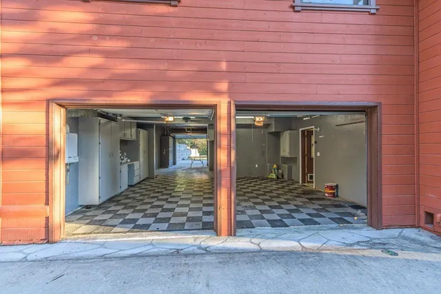 a view of a hall with a dining table and chairs