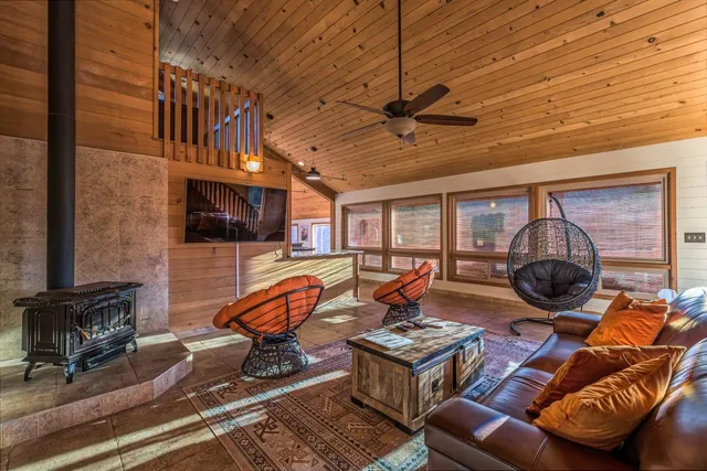 a living room with furniture a flat screen tv and a table